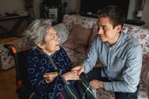 son sitting with mother who has dementia
