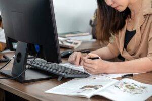 woman infront of a computer completing a form